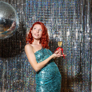 front view young female celebrating christmas on party with disco ball on a bright background new year fun fashion dance xmas